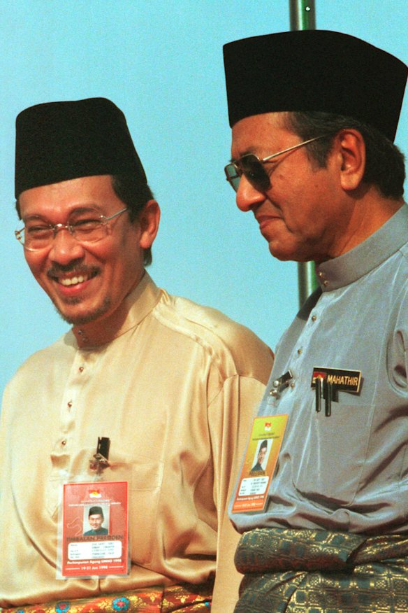 Anwar Ibrahim, left, stands next to Malaysian Prime Minister Mahathir Mohamad in 1998.