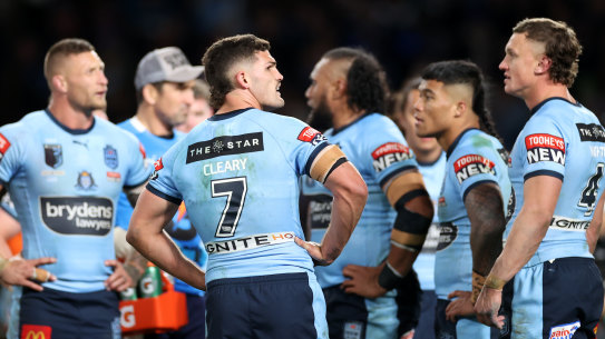The Blues gather under the posts after conceding a try.
