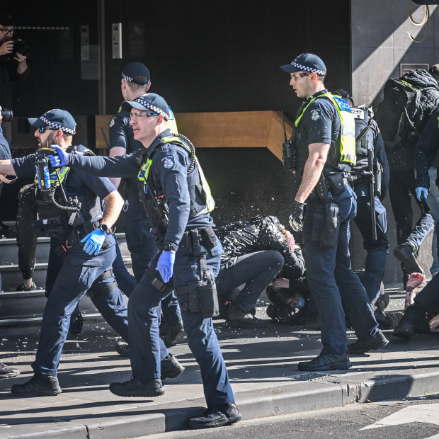 Police officers use capsicum spray during a demonstration in Melbourne’s CBD last Saturday.