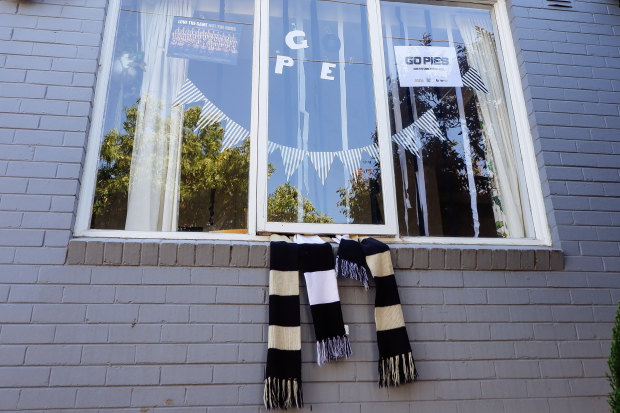 Glenn Peters hangs his Pies scarf outside his window.