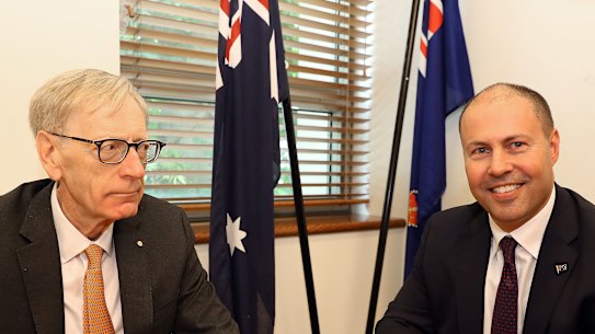 Pretty uncomfortable: Commissioner Kenneth Hayne and Josh Frydenberg at their extremely awkward photo opportunity on Friday.