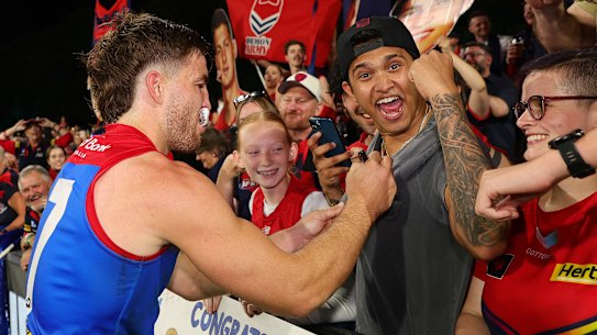 Jack Viney signs an autograph.