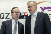 Alan Joyce and Anthony Albanese at a Yes campaign event at Sydney Airport last month.