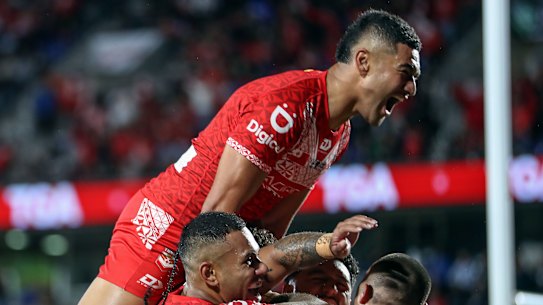 Isaiya Katoa celebrates Siliva Havili’s try for Tonga XIII against New Zealand.