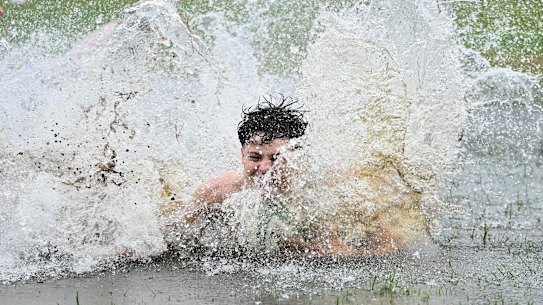 Boys make the most of a flooded park in Rosalie in Brisbane’s inner west.