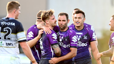 Cameron Smith congratulates teammate Cameron Munster on his try against the Cowboys.