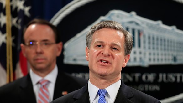 FBI Director Christopher Wray with Deputy Attorney General Rod Rosenstein, speaks during a news conference blowing the whistle on China's hacking operation.