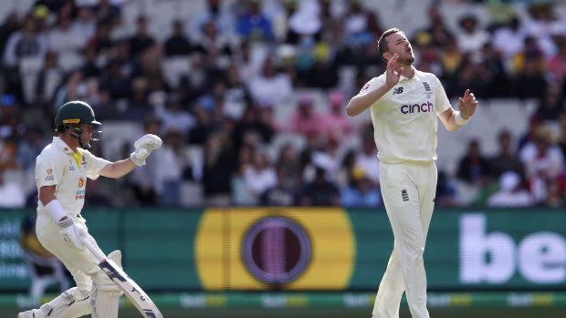 Ollie Robinson bowls as Marcus Harris looks on. 