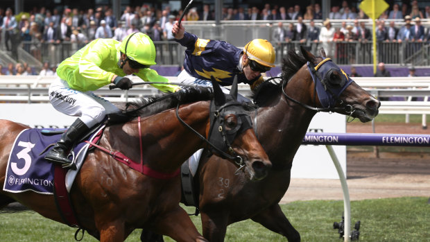 Loyalty Man (yellow cap) holds off Manuel to take out the first race at Flemington.