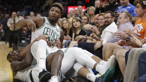 Scuffle: Boston's Marcus Smart is held back by teammates during the pre-season game against Cleveland.