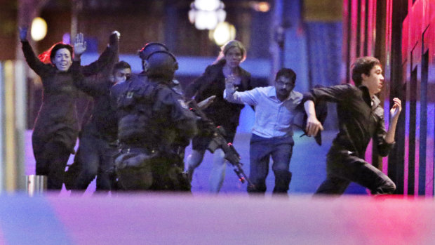 Hostages run from the Lindt Cafe towards Special Operations police on December 16, 2014.