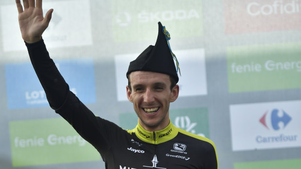 Simon Yates celebrates after stage 14.