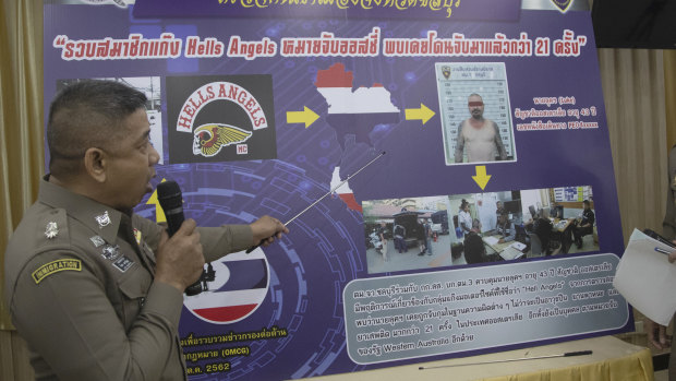 An immigration officer uses a timeline information board describing details of Australian national Luke Anderson during a press conference at the Immigration Bureau in Bangkok.