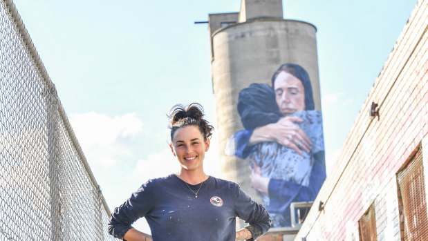 Peace, love and understanding: Artist Loretta Lizzio in front of the Jacinda Ardern mural in Brunswick.