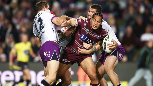 Wriggle room: Manly's Martin Taupau is surrounded by Storm defenders.