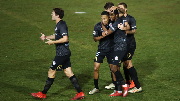Melbourne City's Shayon Harrison is embraced by teammates after scoring against Sydney FC.