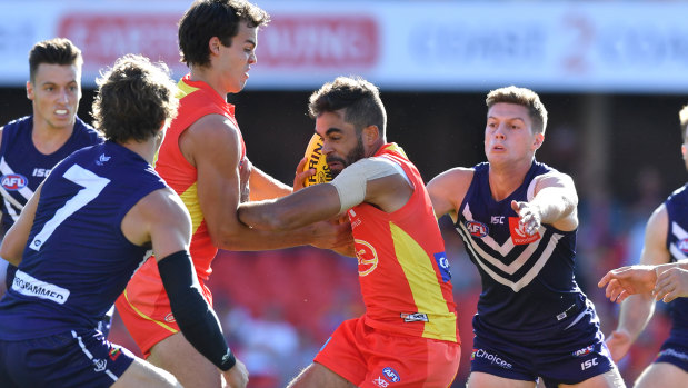 Friendly fire: Gold Coast's Jack Martin gets entangled in the pack during the round 2 clash against Fremantle at Metricon Stadium.