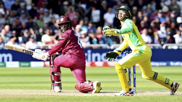Australia's wicketkeeper Alex Carey, right, reacts after West Indies' Shai Hope, played a shot.