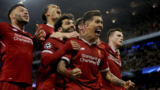 Red hot: Liverpool's Roberto Firmino celebrates with his teammates after scoring his side's second goal.