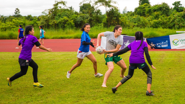 Grassroots: Charlotte Caslick playing rugby with children in Laos with Pass It Back.
