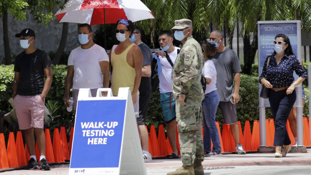 People line up at a COVID-19 testing site in Miami Beach, Florida, this week.