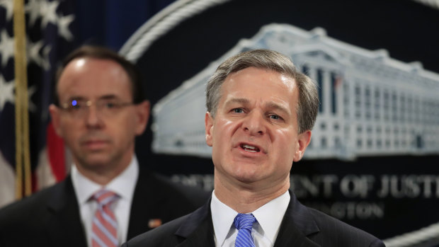 FBI Director Christopher Wray with Deputy Attorney General Rod Rosenstein, speaks during a news conference blowing the whistle on China's hacking operation.