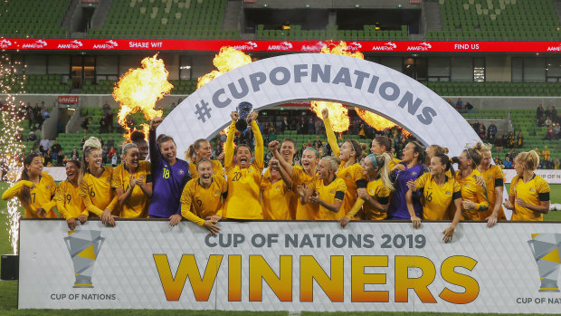 Home and hosed: Australian players hold the Cup of Nations trophy after their win over Argentina at AAMI Park in Melbourne.