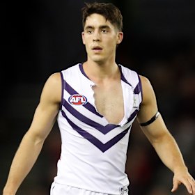 Docker Adam Cerra’s jumper is ripped in the physical clash with the Bombers.