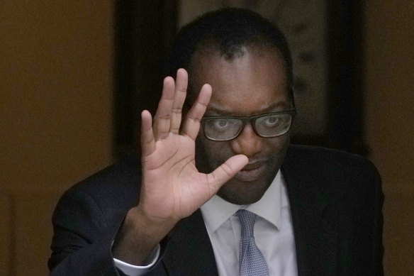 Britain’s former Chancellor of the Exchequer Kwasi Kwarteng waves to the media as he leaves 11 Downing Street after being sacked by the Prime Minister Liz Truss.