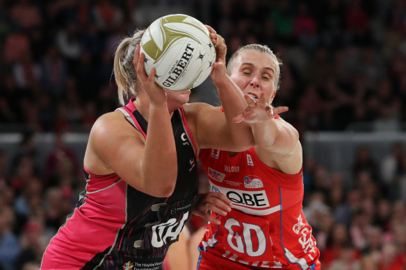Tight tussle: Eleanor Cardwell of the Thunderbirds competes for the ball against NSW’s Maddy Turner.