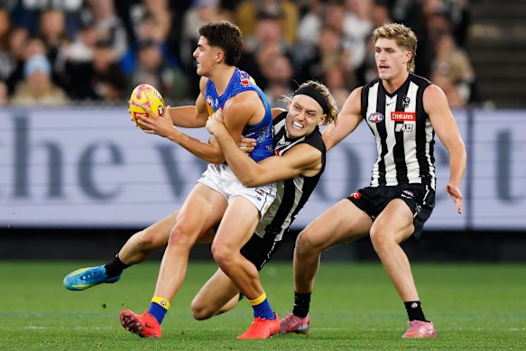 Moore tackles Josh Lindsay before Scott Pendlebury has to leave his 433rd game due to a hamstring issue.