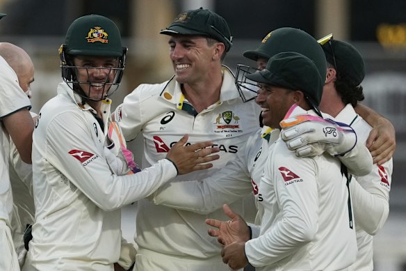 Australia’s captain Pat Cummins celebrates with teammates after defeating West Indies. 