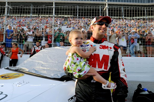 Greg Biffle holds his daughter Emma before a race in 2012.