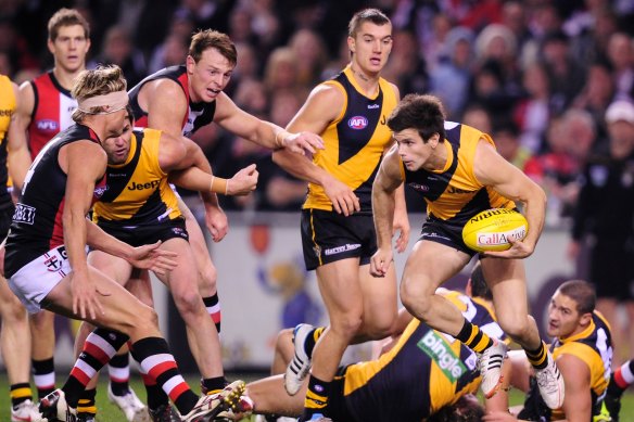 Richmond’s Trent Cotchin looks for a way around the pack at Etihad.