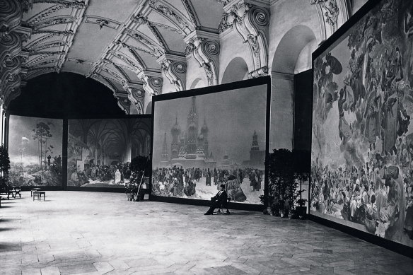 Mucha with the Slav Epic canvases as exhibited in the Klementinum, Prague, 1919.