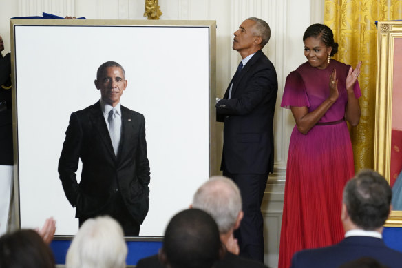 Former first lady Michelle Obama applauds as she looks at former president Barack Obama’s official White House portrait during an unveiling ceremony in the East Room of the White House.