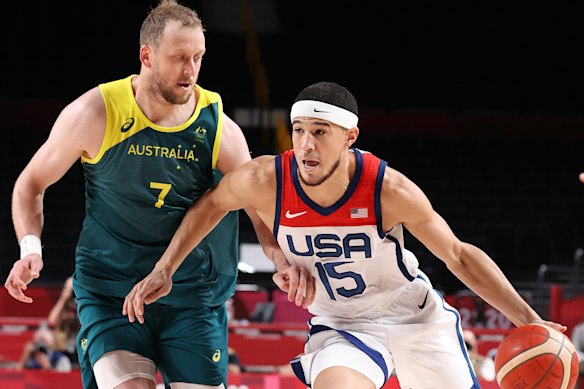 Devin Booker drives against Boomers forward Joe Ingles.