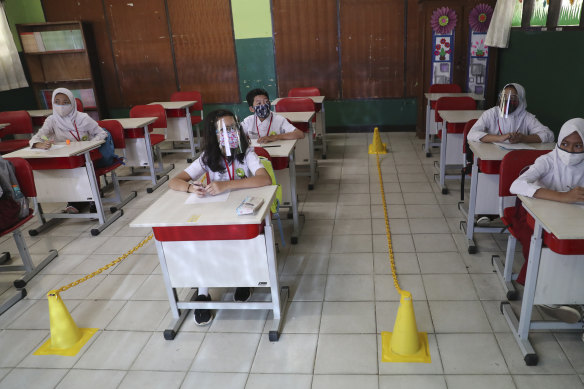 Students sit spaced apart during a class in Bekasi on the outskirts of Jakarta, Indonesia.