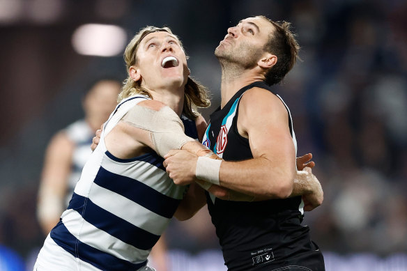 Mark Blicavs of the Cats and Jeremy Finlayson of the Power compete in a ruck contest.