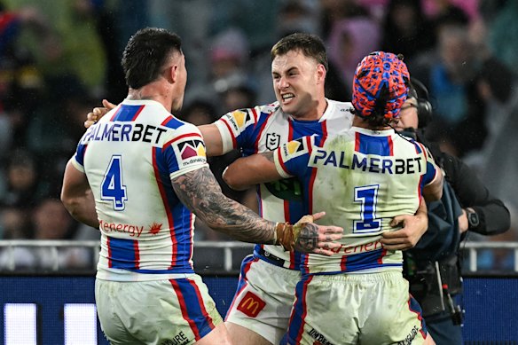 Sandon Smith celebrates his match-winning try with Kalyn Ponga and Bradman Best.