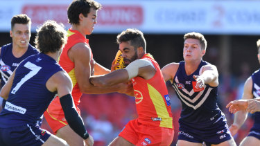 Friendly fire: Gold Coast's Jack Martin gets entangled in the pack during the round 2 clash against Fremantle at Metricon Stadium.