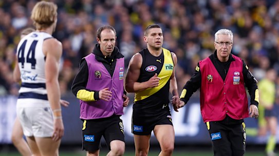 Tom Stewart watches on as Dion Prestia is helped from the ground.