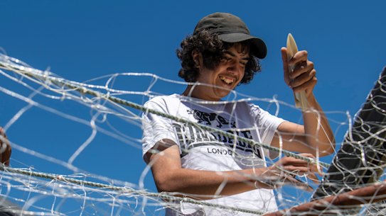 Newton Carriage teaches Bradley Carriage and Newton Bond how to weave a fishing net. 