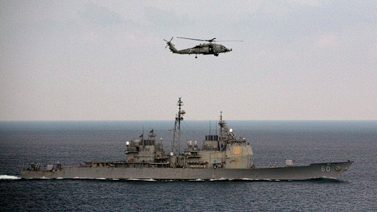 A US Navy helicopter approaches the deck of the aircraft carrier USS Theodore Roosevelt during the 2015 Malabar exercises.