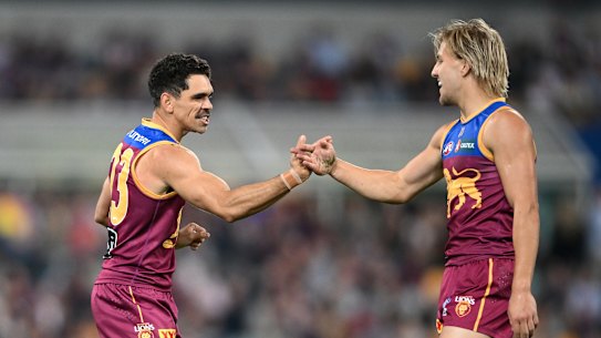 Charlie Cameron of the Lions celebrates kicking a goal with Kai Lohmann of the Lions.