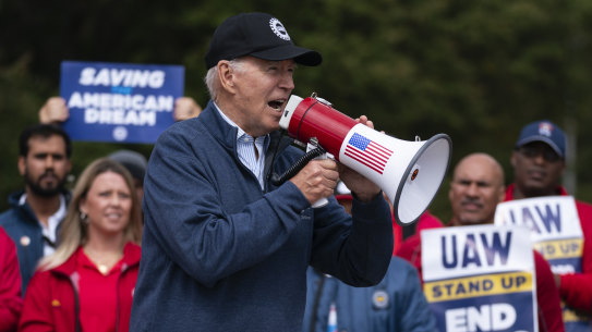 FILE - President Joe Biden speaks to striking United Auto Workers on the picket line in Michigan last year. 