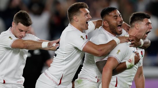 Dominant: England celebrate their upset over New Zealand at International Yokohama Stadium.