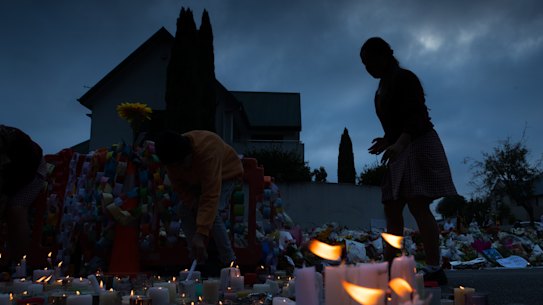 Candles are lit by school children  for the victims of Friday's attacks on Christchurch mosques.