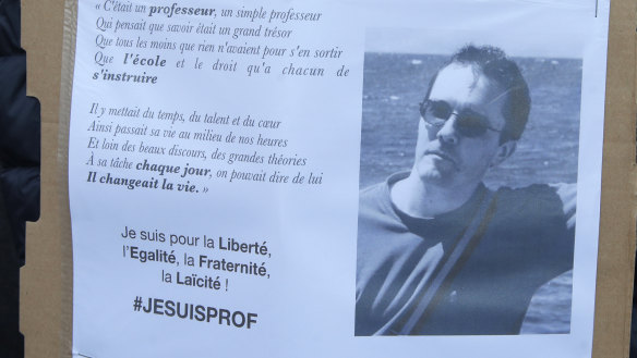 A portrait of slain teacher Samuel Paty is displayed during a demonstration in Paris on Sunday.