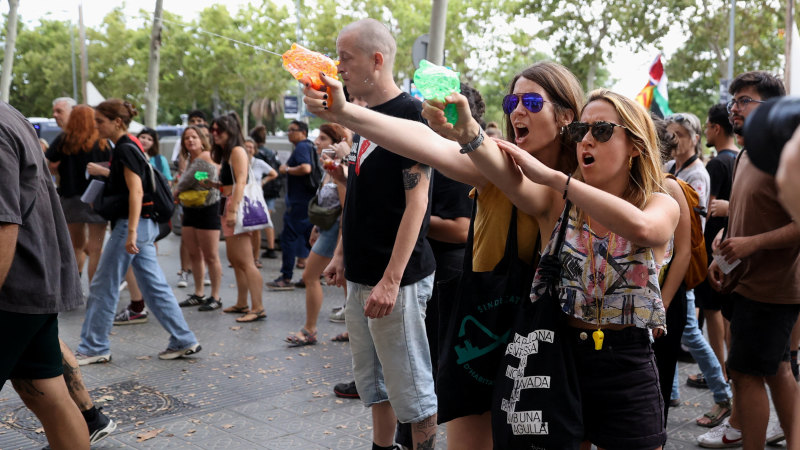 ‘Tourism kills the city’: Protesters soak diners with water pistols